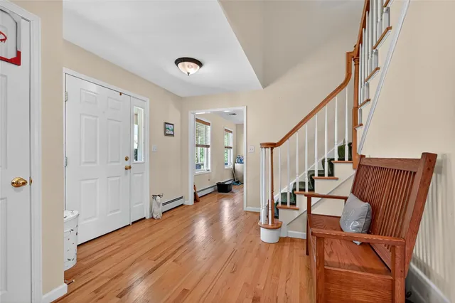 a view of a hallway with wooden floor and staircase