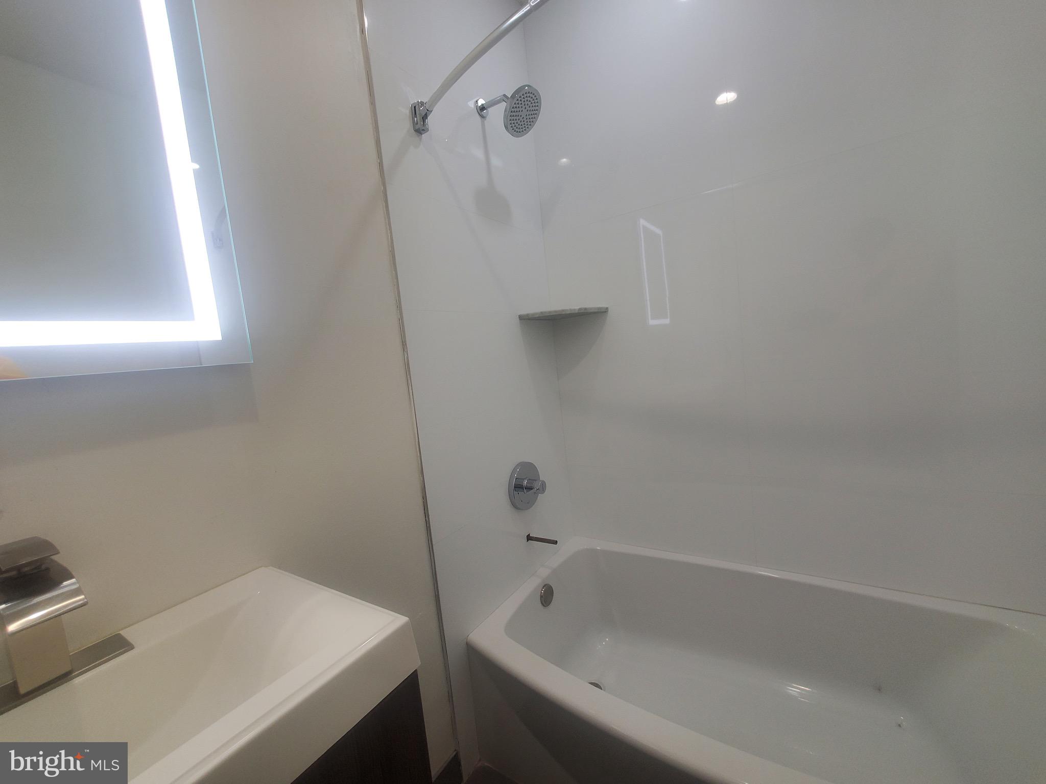1122 Penn Street Northeast, Unit 1 Washington, DC 20002 - Photo 17 of 31 a bathroom with a bathtub and a shower