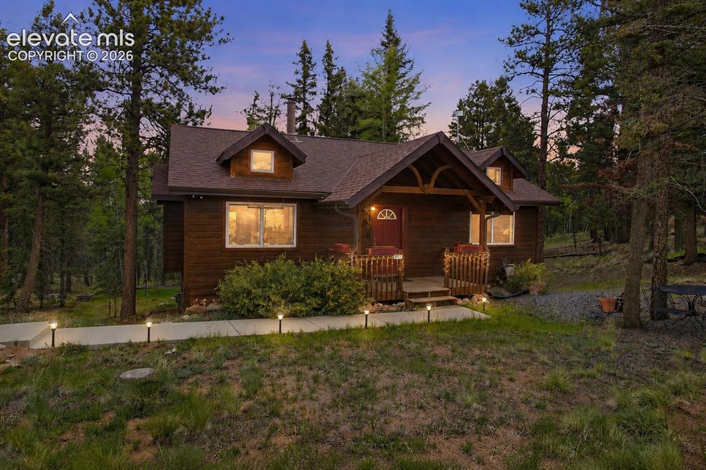 877 North Mountain Estates Road Florissant, CO 80816 - Photo 1 of 23 a front view of a house with garden