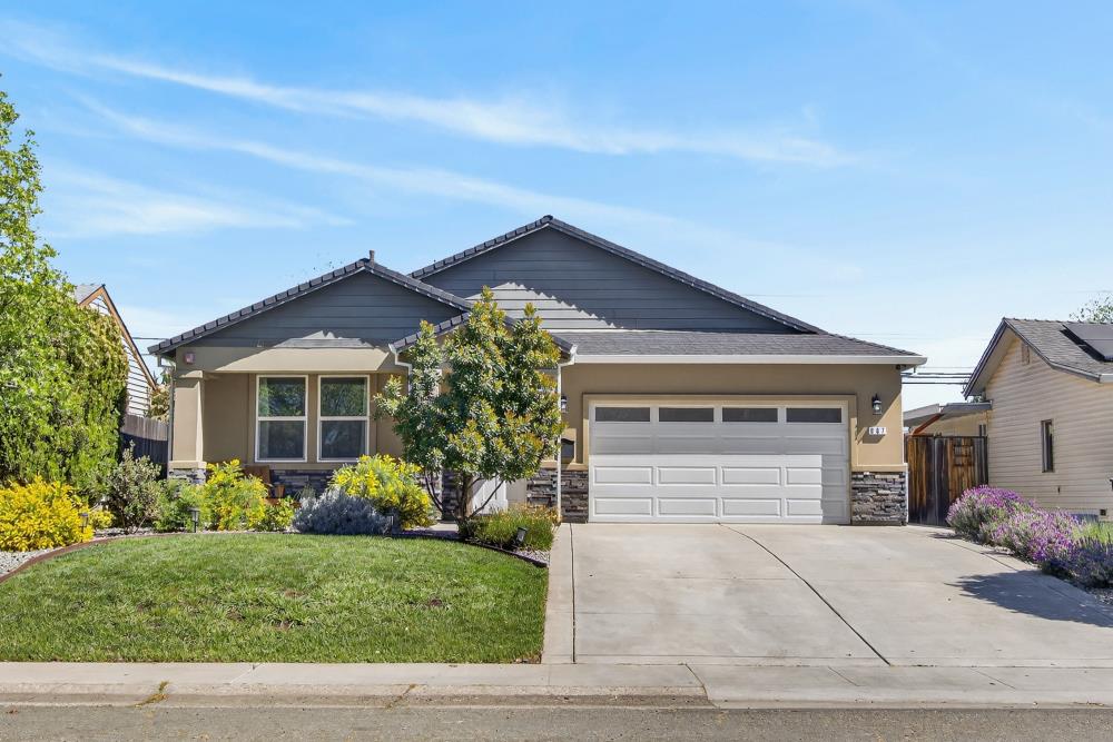 867 J Street Lincoln, CA 95648 - Photo 1 of 53 a front view of a house with a yard and garage