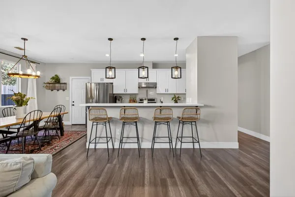 a view of a dining room with furniture window and wooden floor