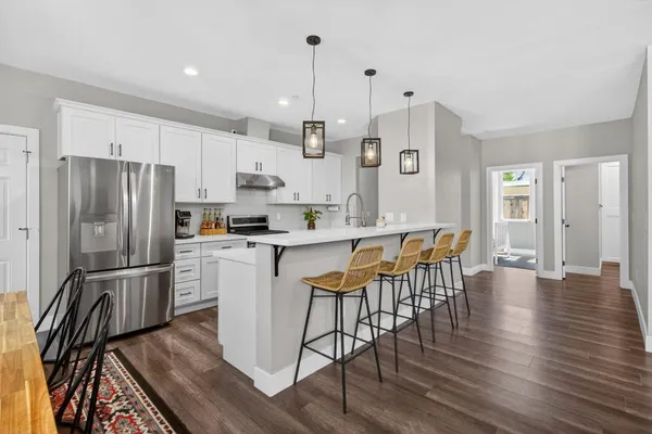 a kitchen with stainless steel appliances a sink and a refrigerator