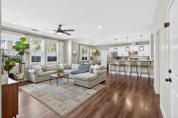 a living room with furniture and a wooden floor