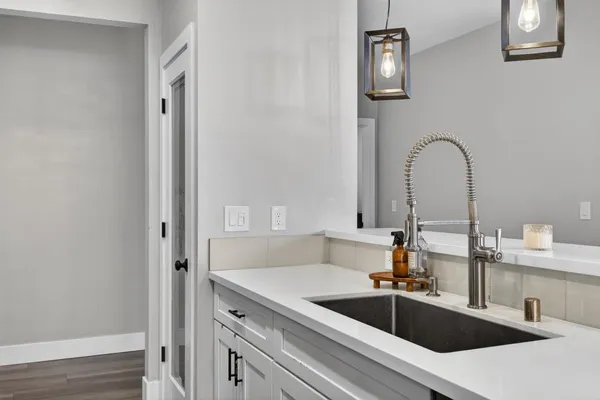 a kitchen with white cabinets and appliances