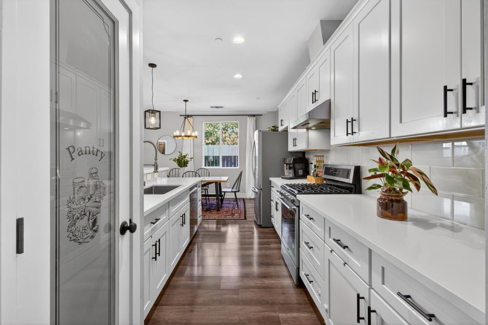 867 J Street Lincoln, CA 95648 - Photo 24 of 53 a kitchen with stainless steel appliances a sink stove and cabinets