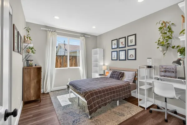 a bedroom with a bed and a painting on the wall