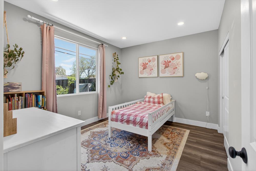 867 J Street Lincoln, CA 95648 - Photo 31 of 53 a bedroom with a bed and a painting on the wall