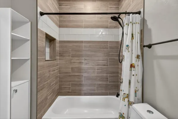 a bedroom with a large bed and a window