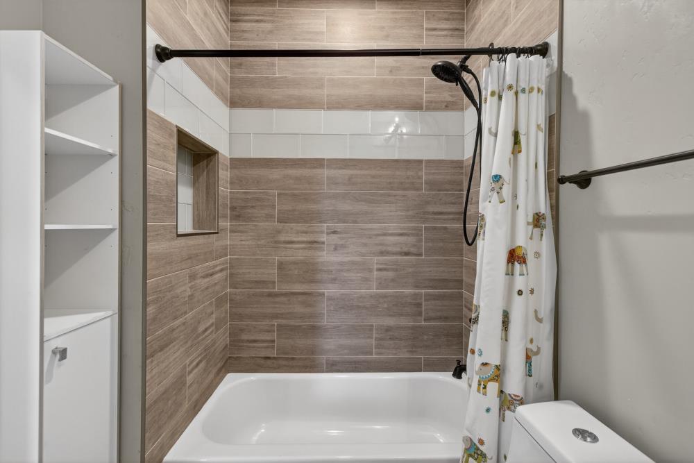 867 J Street Lincoln, CA 95648 - Photo 33 of 53 a bathroom with a bathtub and a shower