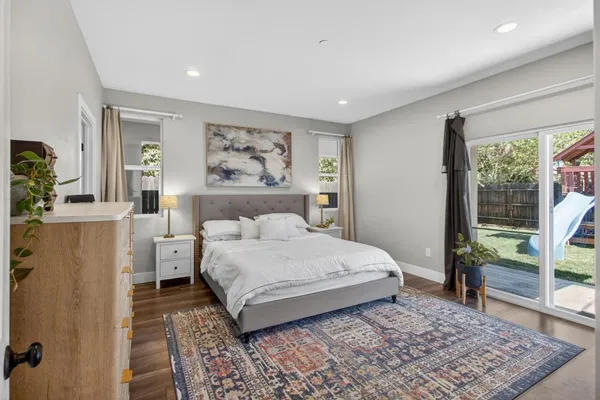 a bedroom with a large bed and a flat screen tv
