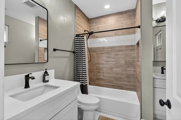 a bathroom with a bathtub and shower
