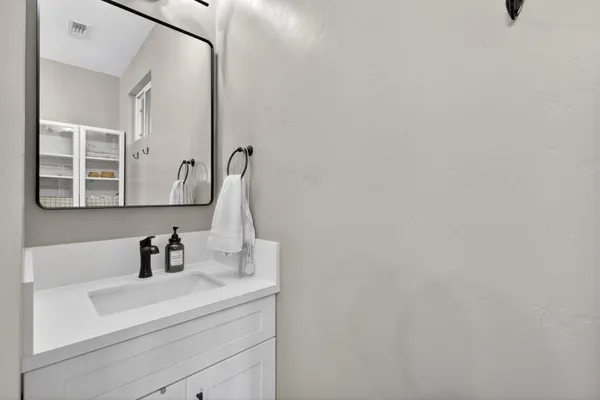 a en suite bathroom with a sink and a mirror