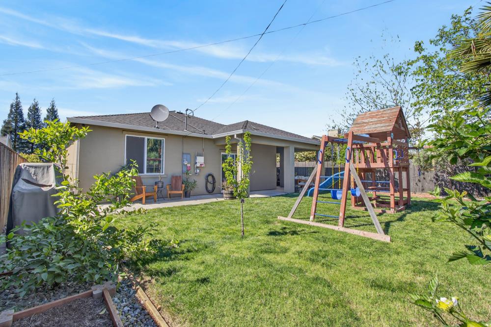 867 J Street Lincoln, CA 95648 - Photo 44 of 53 a view of a house with a backyard and a slide