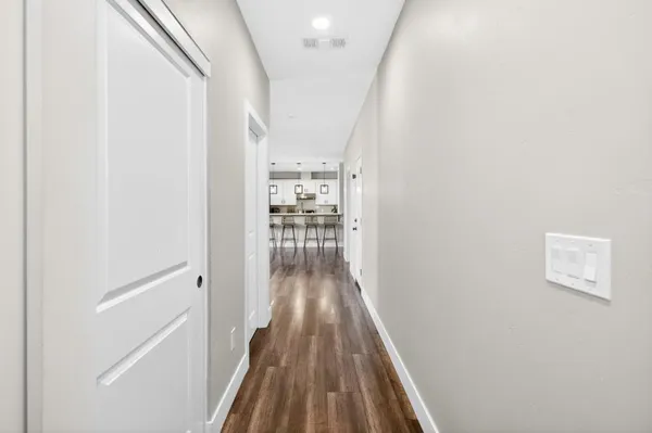 a living room with furniture kitchen view and a window