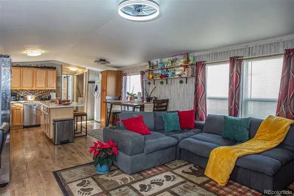 a living room with furniture kitchen and a window