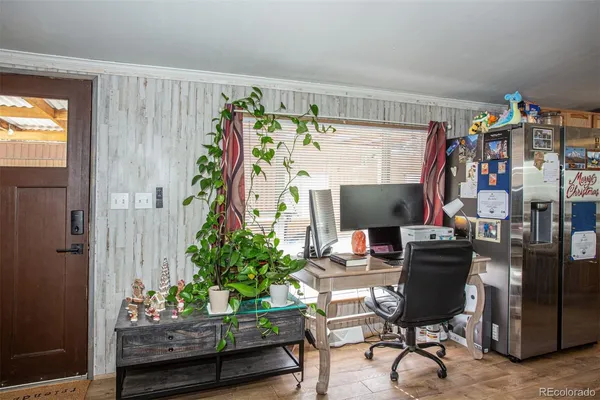 a workspace with furniture and a potted plant