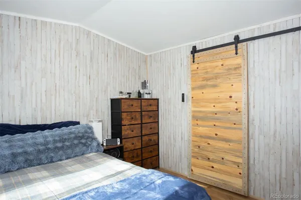 a bedroom with a bed and a dresser