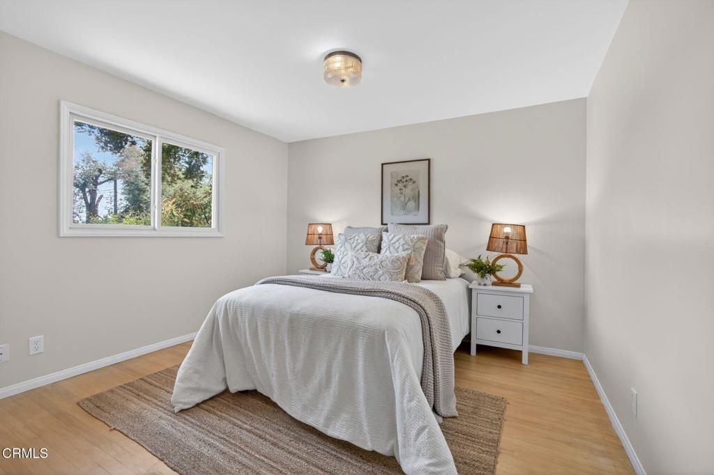 98 Howard Avenue Oak View, CA 93022 - Photo 30 of 72 a bedroom with a bed and wooden floor