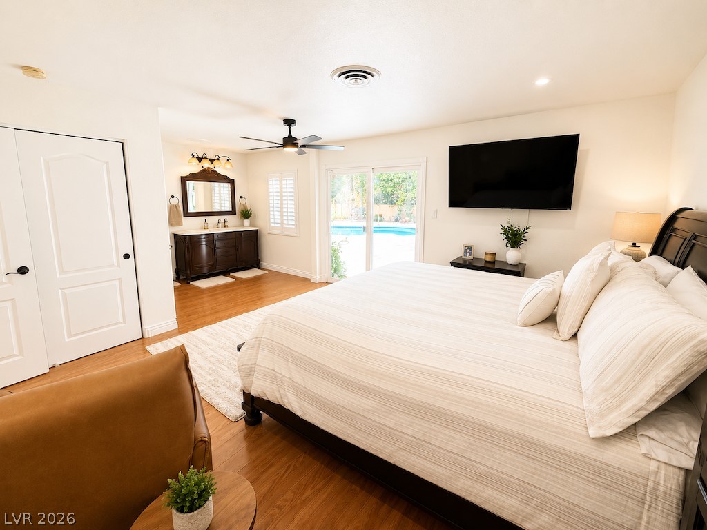 3010 East Viking Road Las Vegas, NV 89121 - Photo 15 of 48 Generous sleeping quarters feature a private vanity, ceiling fan, and direct access to the outdoor pool area.