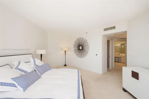 a bedroom with a bed and a mirror