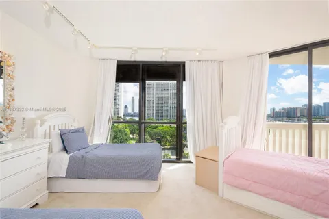 a bedroom with a bed and large window