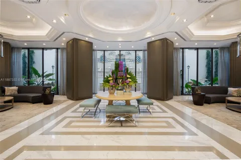 a view of a lobby with furniture and a potted plant