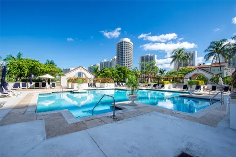 a view of a swimming pool with a patio and a garden
