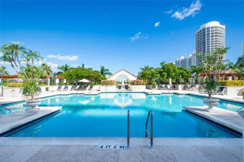 a view of swimming pool with outdoor seating and plants