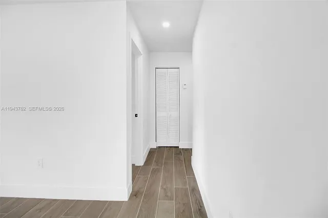 a view of a hallway with wooden floor