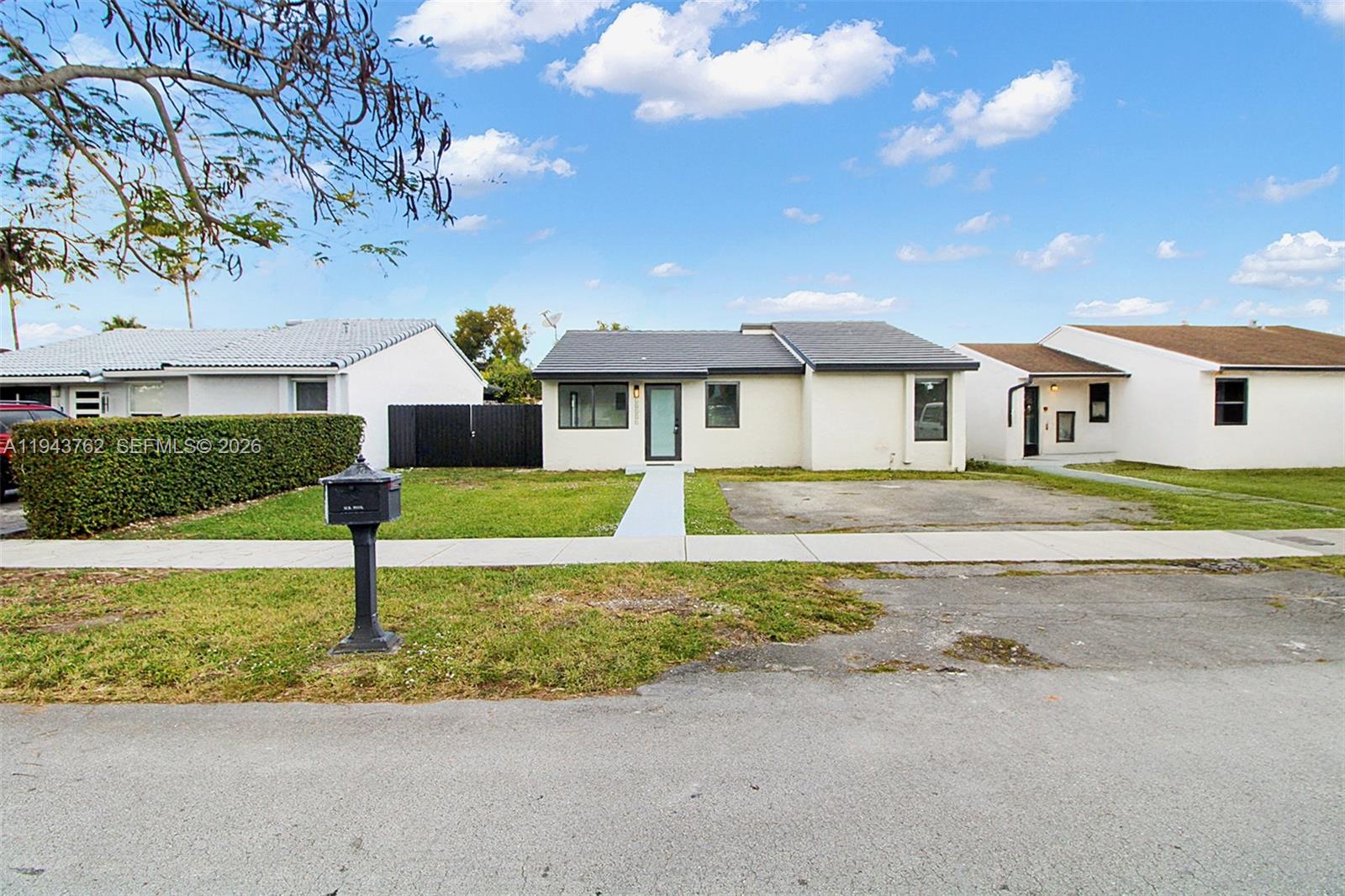 13379 Northwest 3rd Terrace Miami, FL 33182 - Photo 2 of 23 a front view of a house with garden