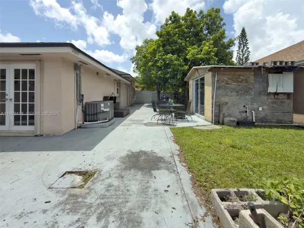 a view of a backyard with plants and a patio