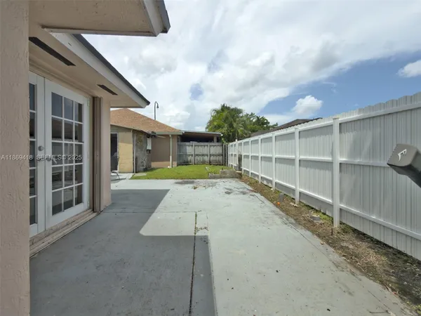 a view of a house with a wooden floor and a yard