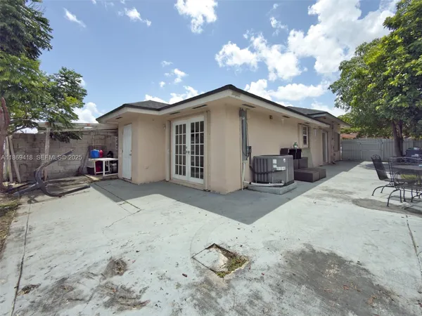 a view of a house with wooden roof and sitting area