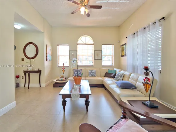 a living room with furniture and a large window