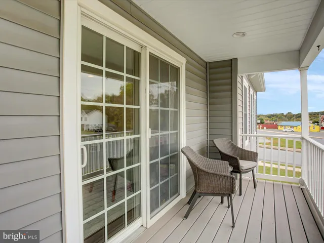 a view of a balcony with chair and table