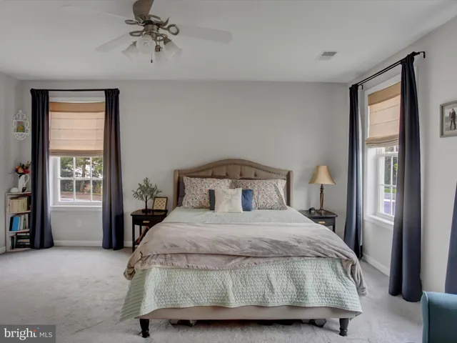 a spacious bedroom with a bed and a couch