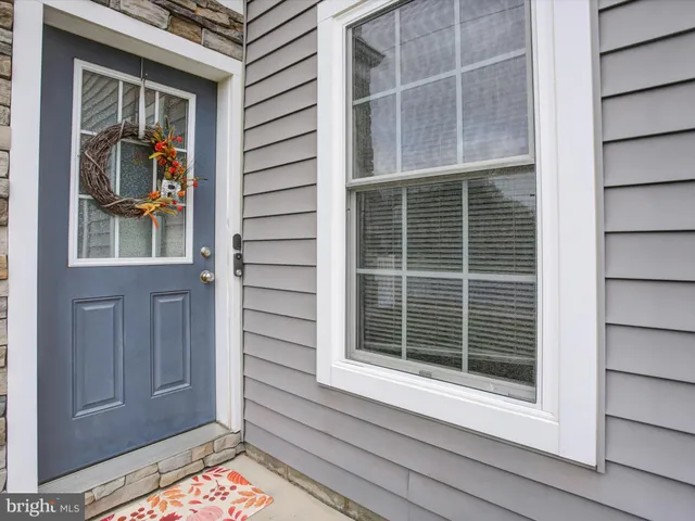 a view of front door and deck of the house