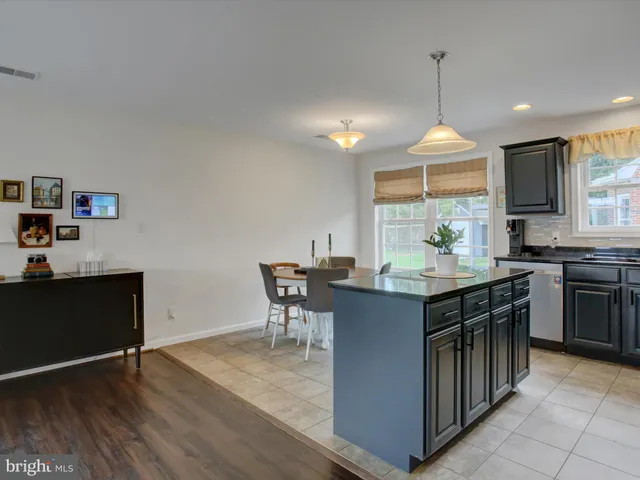 a kitchen with granite countertop a sink stove and cabinets