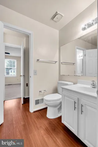 a bathroom with a toilet sink and a mirror