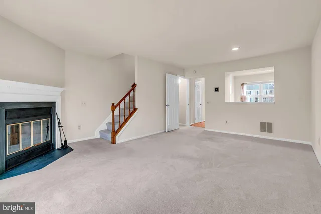 a view of an empty room with a fireplace