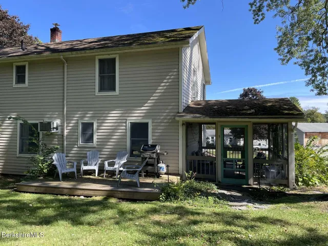a front view of a house with yard and porch