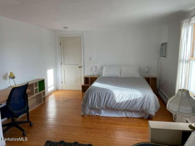 5 Seekonk Road Great Barrington, MA 01230 - Photo 11 of 19 a bedroom with a bed and wooden floor