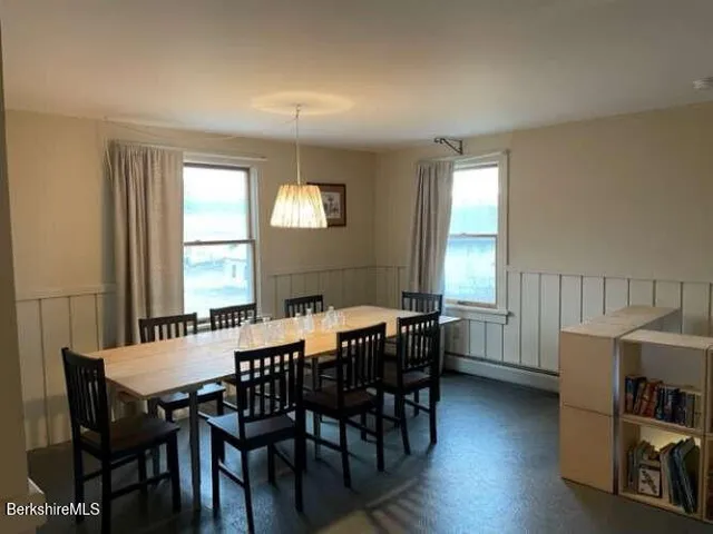 a view of a dining room with furniture and window