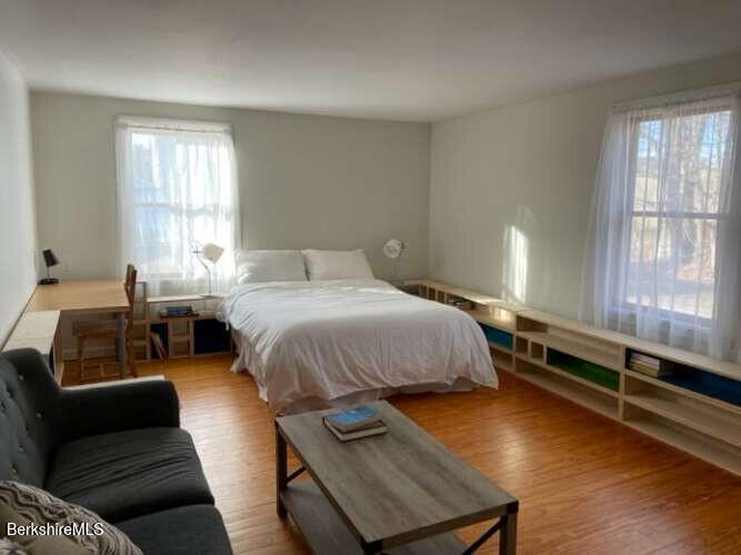 5 Seekonk Road Great Barrington, MA 01230 - Photo 9 of 19 a bedroom with a bed and wooden floor