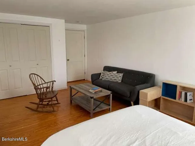 a bedroom with two beds and a couch