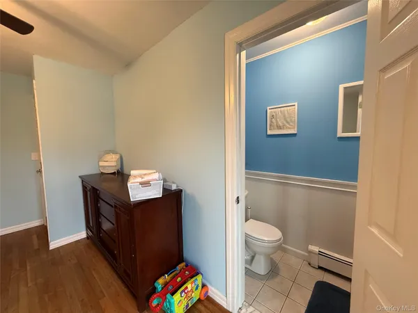 a bathroom with a toilet a sink and a mirror