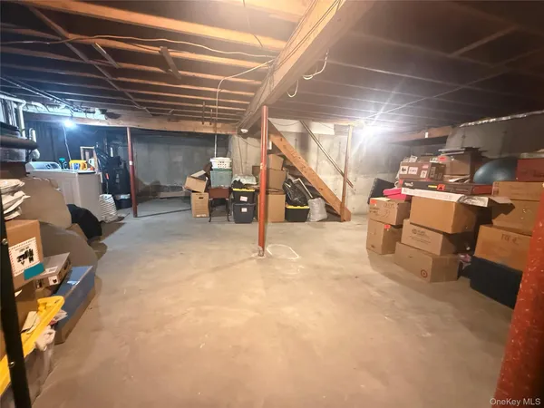 a view of a room with wooden chairs