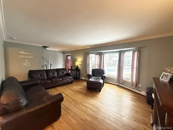a living room with furniture window and wooden floor