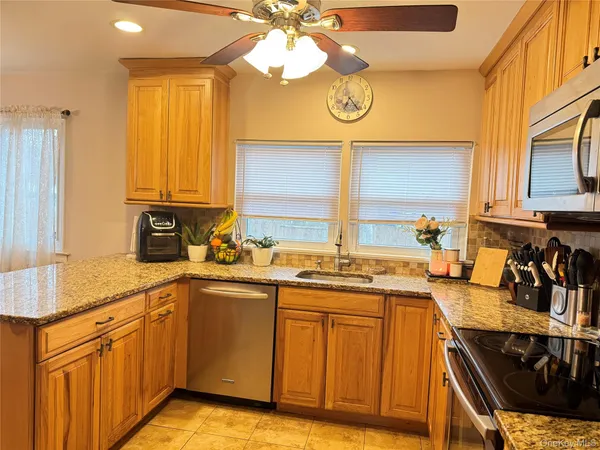 a kitchen with a sink cabinets and window