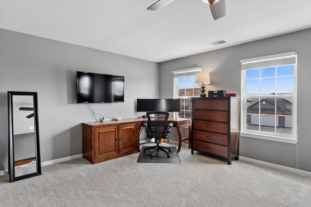 724 North Misty Ridge Drive Romeoville, IL 60446 - Photo 12 of 26 a room with furniture and flat screen tv